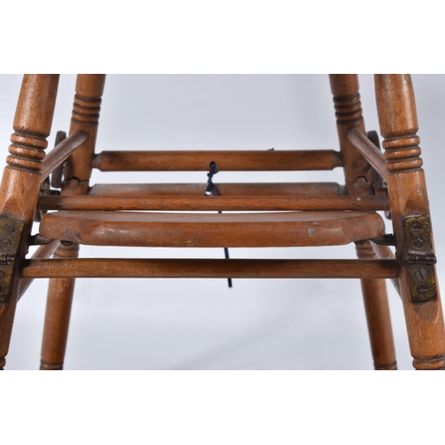 67 - A GERMAN PINE METAMORPHIC DOLLS HIGH CHAIR, c.1910, transfer decoration, tray features a line of col... 