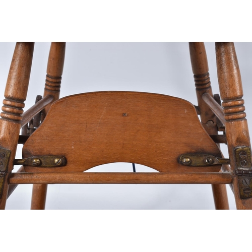 67 - A GERMAN PINE METAMORPHIC DOLLS HIGH CHAIR, c.1910, transfer decoration, tray features a line of col... 