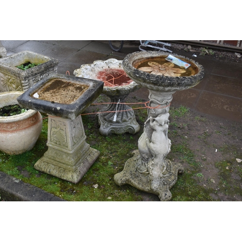1001 - TWO MODERN COMPOSITE BIRD BATHS one with a tree stump style base, squirrel climbing, leaf and vine o... 