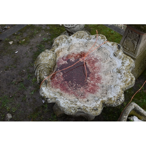 1002 - A MODERN COMPOSITE BIRD BATH in the form of an Oyster shell bowl on a linen swag base with four scro... 