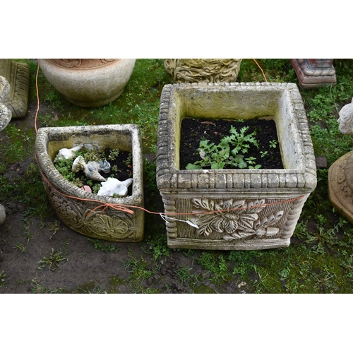 1003 - FOUR MODERN COMPOSITE GARDEN PLANTERS including a square planter with foliate details to each side h... 
