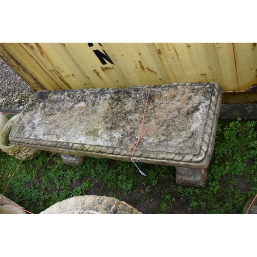 1005 - A MODERN COMPOSITE GARDEN BENCH with rope edges and foliate panels to each rectangular base and rope... 