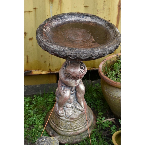 1006 - A MODERN COMPOSITE BIRD BATH in the form of a small child seated on a rock pile holding a bowl (Cond... 