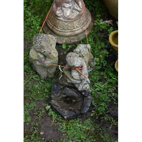 1006 - A MODERN COMPOSITE BIRD BATH in the form of a small child seated on a rock pile holding a bowl (Cond... 