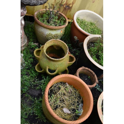 1007 - SIXTEEN PLANT POTS including a pair of green glazed pots with two foliate panels to each, diameter 3... 