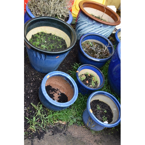 1008 - TWELVE BLUE GLAZED GARDEN PLANT POTS of differing sizes and styles the largest diameter being 41cm (... 