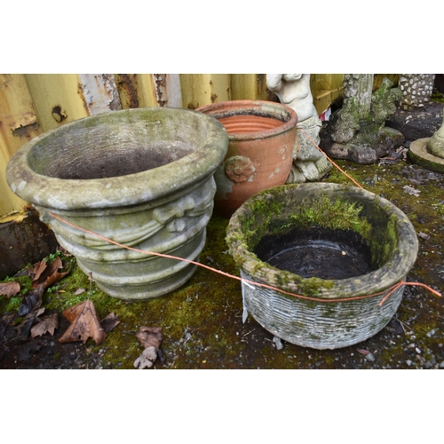 1014 - THREE COMPOSITE GARDEN PLANTERS the largest with ribbon and bow detail diameter 52cm, a wicker baske... 