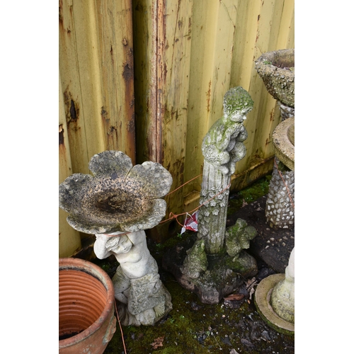 1015 - A MODERN COMPOSITE BIRD BATH in the form of a small child seated on a tree stump holding a flower sh... 