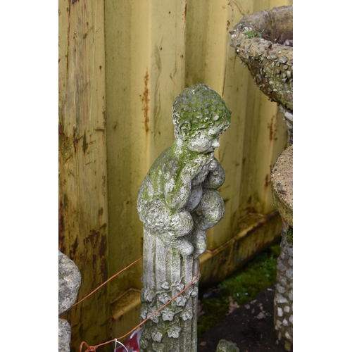 1015 - A MODERN COMPOSITE BIRD BATH in the form of a small child seated on a tree stump holding a flower sh... 