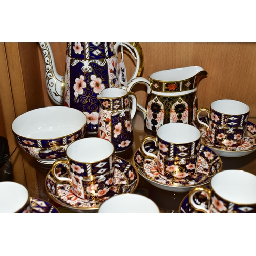 349 - A ROYAL CROWN DERBY TRADITIONAL IMARI 2451 COFFEE SET AND AN OLD IMARI 1128 CREAM JUG, the coffee se... 