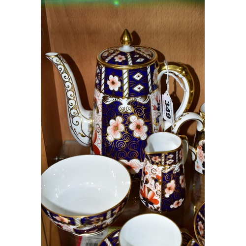 349 - A ROYAL CROWN DERBY TRADITIONAL IMARI 2451 COFFEE SET AND AN OLD IMARI 1128 CREAM JUG, the coffee se... 