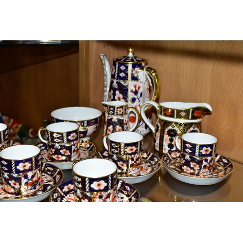 349 - A ROYAL CROWN DERBY TRADITIONAL IMARI 2451 COFFEE SET AND AN OLD IMARI 1128 CREAM JUG, the coffee se... 