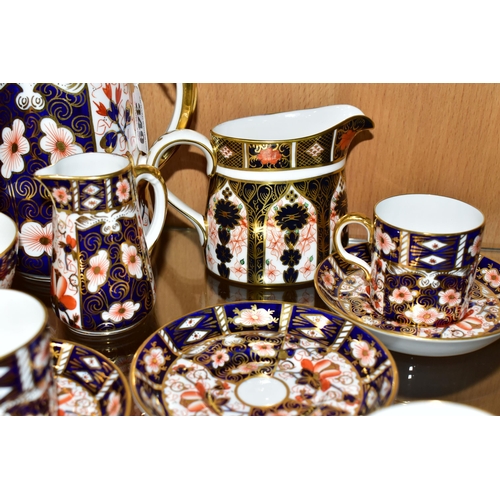 349 - A ROYAL CROWN DERBY TRADITIONAL IMARI 2451 COFFEE SET AND AN OLD IMARI 1128 CREAM JUG, the coffee se... 