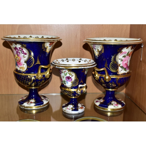 350 - SEVEN VICTORIAN PORCELAIN TWIN HANDLED URNS, hand painted with panels of flowers on a fish scale blu... 