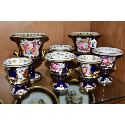 350 - SEVEN VICTORIAN PORCELAIN TWIN HANDLED URNS, hand painted with panels of flowers on a fish scale blu... 