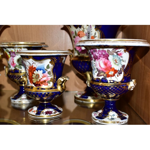 350 - SEVEN VICTORIAN PORCELAIN TWIN HANDLED URNS, hand painted with panels of flowers on a fish scale blu... 