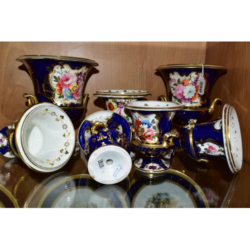 350 - SEVEN VICTORIAN PORCELAIN TWIN HANDLED URNS, hand painted with panels of flowers on a fish scale blu... 