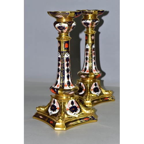 360 - A PAIR OF ROYAL CROWN DERBY 1128 'SOLID GOLD BAND' CANDLESTICKS, of tapering form, the octagonal bas... 