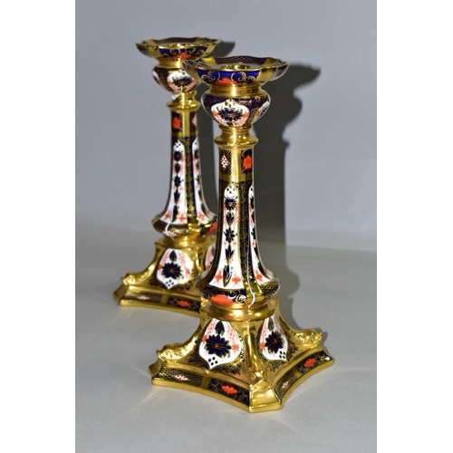 360 - A PAIR OF ROYAL CROWN DERBY 1128 'SOLID GOLD BAND' CANDLESTICKS, of tapering form, the octagonal bas... 