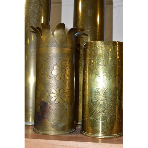 392 - A COLLECTION OF FOUR PIECES OF TRENCH ART, comprising two plain brass shell cases, height 35cm, a fl... 