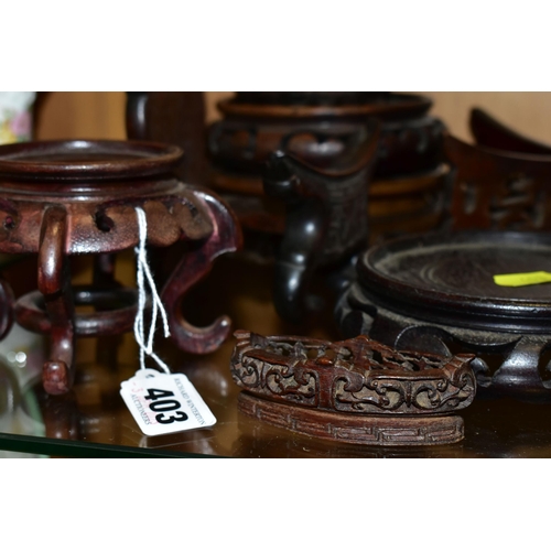 403 - A QUANTITY OF WOODEN VASE STANDS, comprising an Arts & Crafts style tobacco jar with carved detail, ... 