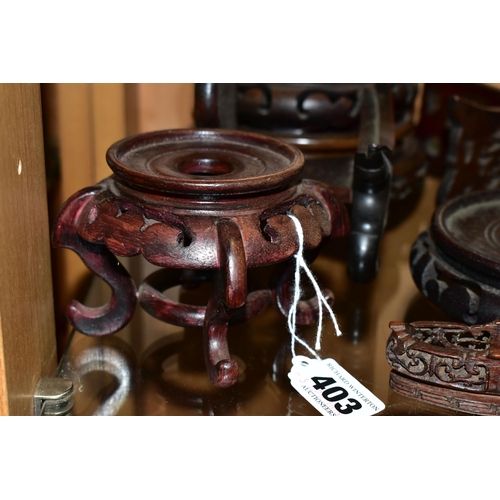 403 - A QUANTITY OF WOODEN VASE STANDS, comprising an Arts & Crafts style tobacco jar with carved detail, ... 