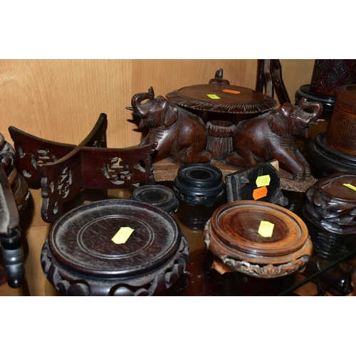 403 - A QUANTITY OF WOODEN VASE STANDS, comprising an Arts & Crafts style tobacco jar with carved detail, ... 