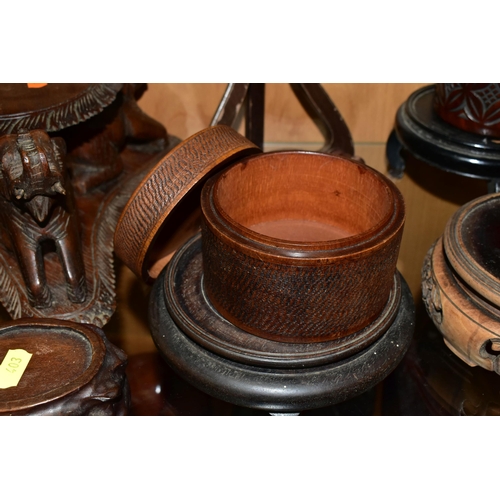 403 - A QUANTITY OF WOODEN VASE STANDS, comprising an Arts & Crafts style tobacco jar with carved detail, ... 