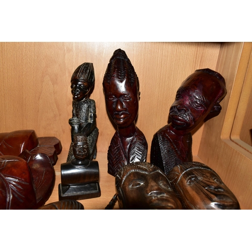 404 - A COLLECTION OF CARVED HARDWOOD ORIENTAL AND TRIBAL WALL MASKS BUSTS AND FIGURINES, comprising seven... 