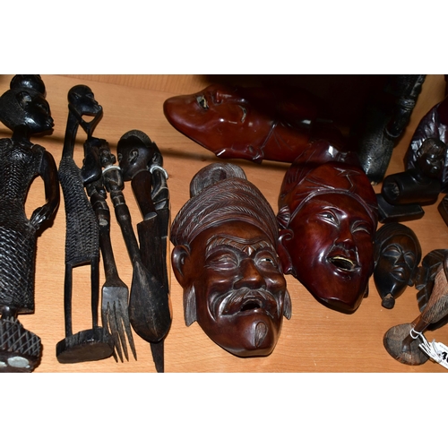 404 - A COLLECTION OF CARVED HARDWOOD ORIENTAL AND TRIBAL WALL MASKS BUSTS AND FIGURINES, comprising seven... 