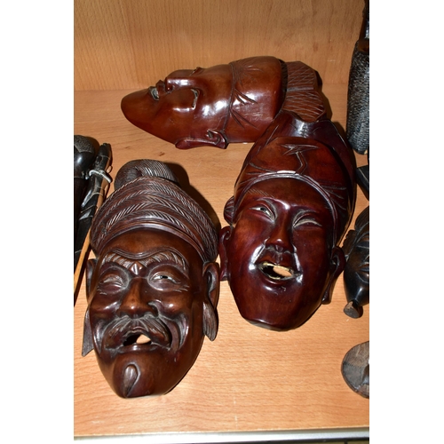 404 - A COLLECTION OF CARVED HARDWOOD ORIENTAL AND TRIBAL WALL MASKS BUSTS AND FIGURINES, comprising seven... 