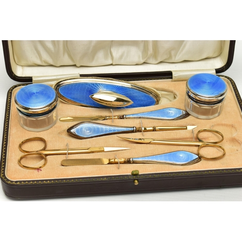 153 - AN EARLY 20TH CENTURY CASED SILVER GUILLOCHE ENAMEL MANICURE SET, eight piece set comprising of cuti... 