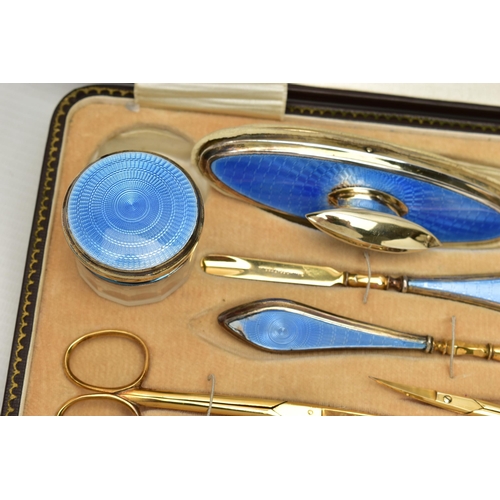 153 - AN EARLY 20TH CENTURY CASED SILVER GUILLOCHE ENAMEL MANICURE SET, eight piece set comprising of cuti... 