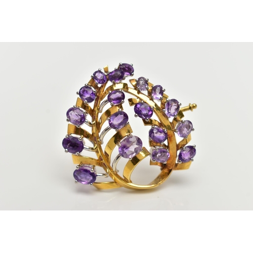 20 - A YELLOW METAL AMETHYST 'LOTOS' SPRAY BROOCH, foliage spray design set with eighteen oval cut amethy... 