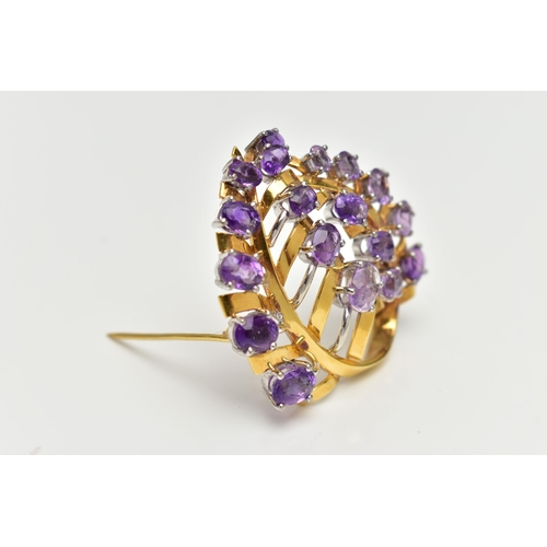 20 - A YELLOW METAL AMETHYST 'LOTOS' SPRAY BROOCH, foliage spray design set with eighteen oval cut amethy... 