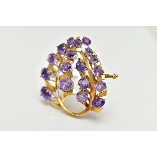 20 - A YELLOW METAL AMETHYST 'LOTOS' SPRAY BROOCH, foliage spray design set with eighteen oval cut amethy... 