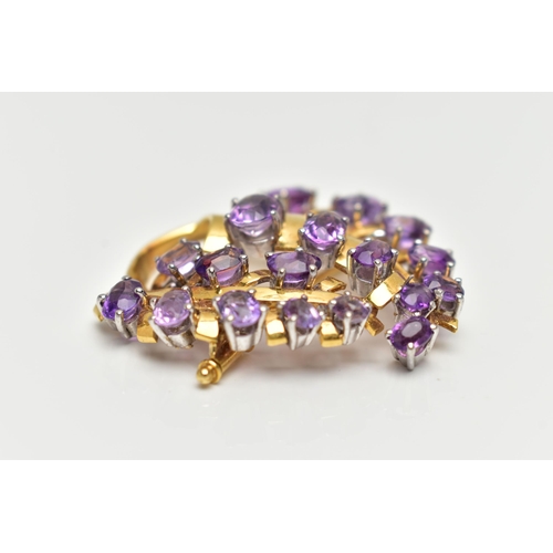 20 - A YELLOW METAL AMETHYST 'LOTOS' SPRAY BROOCH, foliage spray design set with eighteen oval cut amethy... 