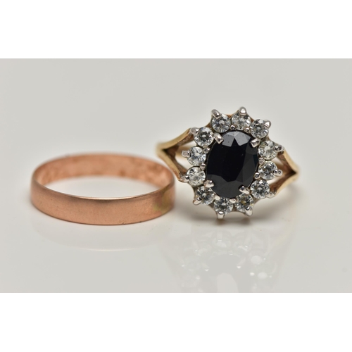 22 - TWO 9CT GOLD RINGS, the first an oval cluster ring, centring on a four claw set, oval cut deep blue ... 