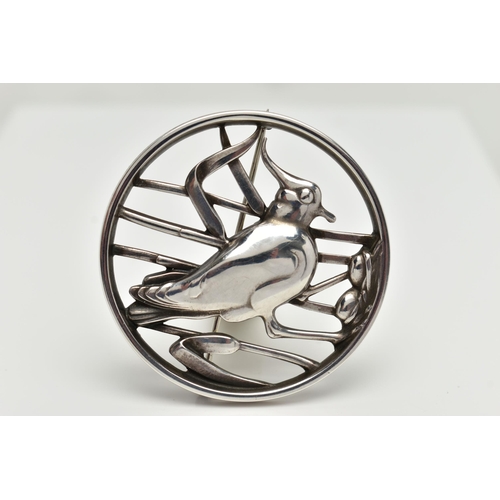 36 - A GEORG JENSEN SILVER BROOCH, of an openwork circular form displaying a bird in a nest within reeds,... 