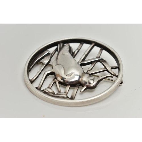 36 - A GEORG JENSEN SILVER BROOCH, of an openwork circular form displaying a bird in a nest within reeds,... 