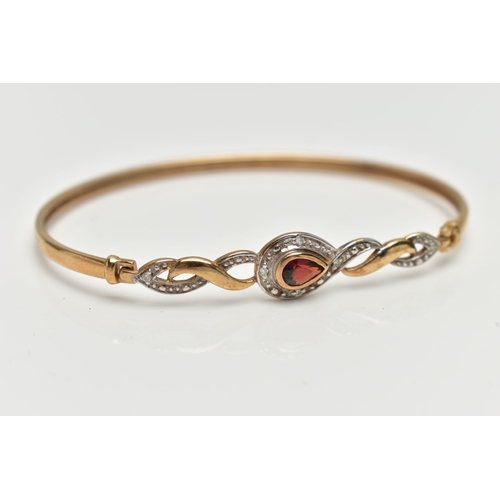 42 - A 9CT GOLD GARNET AND DIAMOND SET BANGLE, thin band, locking hinged clasp set with a pear cut garnet... 