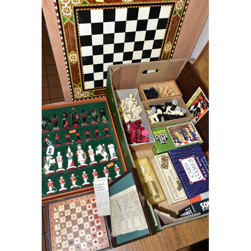 438 - A BOX OF ASSORTED CHESS SETS, PLAYING CARDS AND DOMINOS,  to include two unused sets of Bridge playi... 