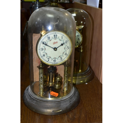 430 - TWO BRASS ANNIVERSARY CLOCKS, comprising one with a glass dome mechanism marked 72632, with key (gla... 