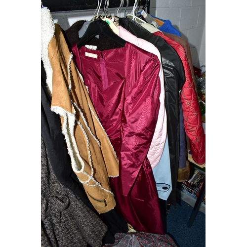 575 - A RAIL AND TWO BOXES OF LADIES CLOTHING, to include coats, jackets, faux furs, sheepskins, skirts an... 