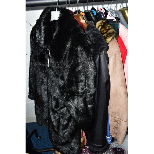 575 - A RAIL AND TWO BOXES OF LADIES CLOTHING, to include coats, jackets, faux furs, sheepskins, skirts an... 