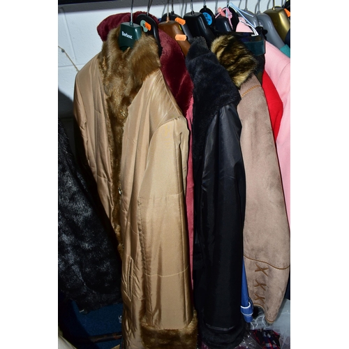 575 - A RAIL AND TWO BOXES OF LADIES CLOTHING, to include coats, jackets, faux furs, sheepskins, skirts an... 
