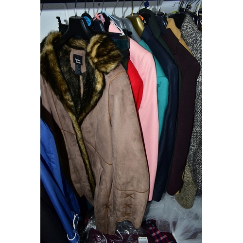 575 - A RAIL AND TWO BOXES OF LADIES CLOTHING, to include coats, jackets, faux furs, sheepskins, skirts an... 