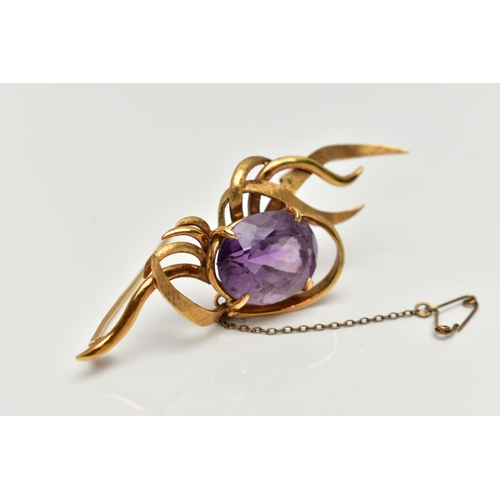 1 - A YELLOW METAL AMETHYST SPRAY BROOCH, designed with a four claw set, oval cut amethyst, within a spr... 