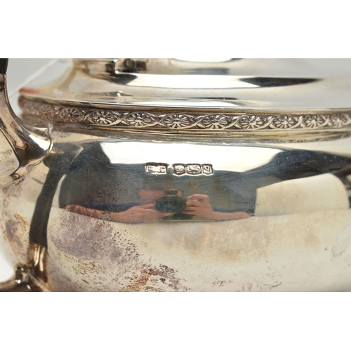 231 - A GEORGE V SILVER TEA POT OF SHAPED OVAL FORM, ebonised fitments, foliate cast rim and feet, makers ... 