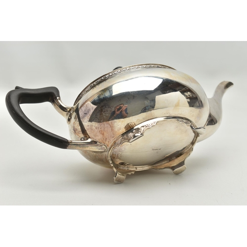 231 - A GEORGE V SILVER TEA POT OF SHAPED OVAL FORM, ebonised fitments, foliate cast rim and feet, makers ... 